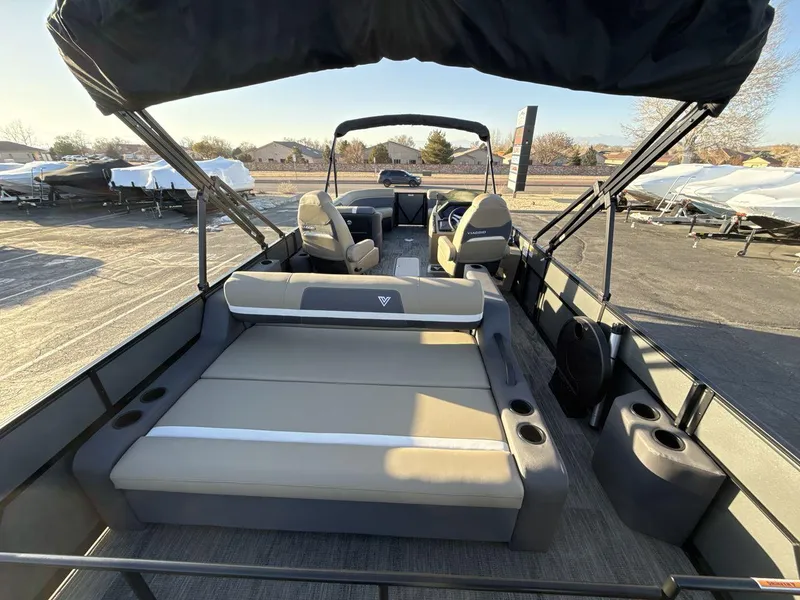 Slide: The Image of 2025 Viaggio x24s boat interior with seating and canopy, parked outdoors. - 9