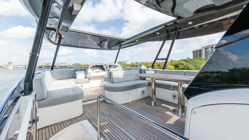 Slide: The Image of Luxurious 2016 Monte Carlo Yachts MCY 65 deck with elegant seating and scenic views. - 10