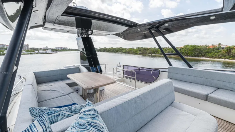 Slide: The Image of Luxurious 2016 Monte Carlo Yachts MCY 65 deck with elegant seating and scenic water view. - 16