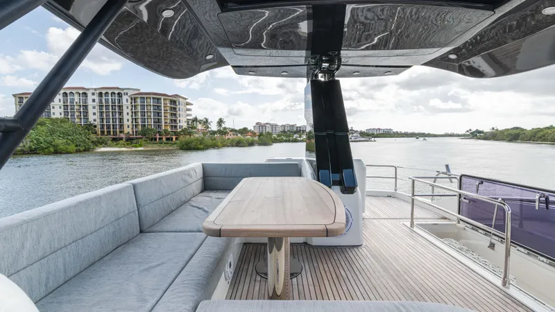 Slide: The Image of Luxurious 2016 Monte Carlo Yachts MCY 65 deck with seating, overlooking scenic waterfront. - 19