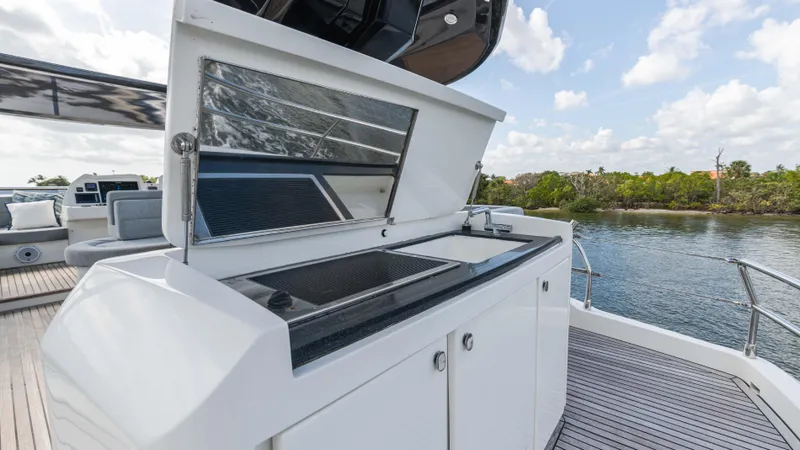 Slide: The Image of Outdoor kitchen on 2016 Monte Carlo Yachts MCY 65, featuring sleek design and scenic water view. - 20