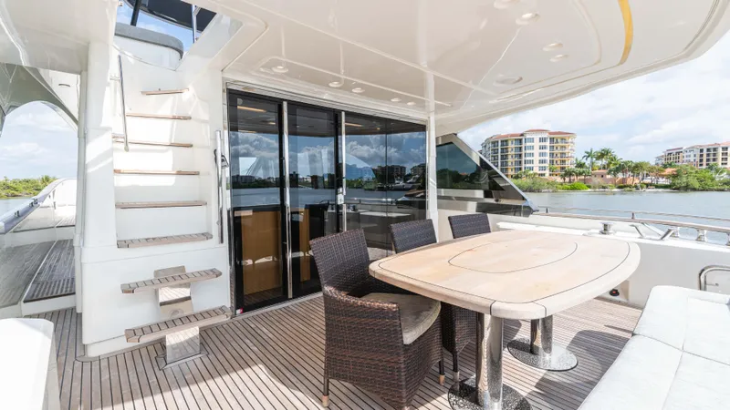 Slide: The Image of Luxurious 2016 Monte Carlo Yachts MCY 65 deck with dining area and scenic waterfront view. - 23