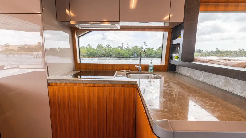 Slide: The Image of Luxurious kitchen interior of 2016 Monte Carlo Yachts MCY 65 with scenic window view. - 31