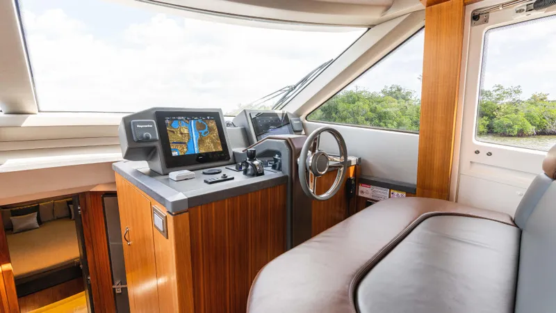 Slide: The Image of 2016 Monte Carlo Yachts MCY 65 helm with navigation screens and luxurious interior. - 38