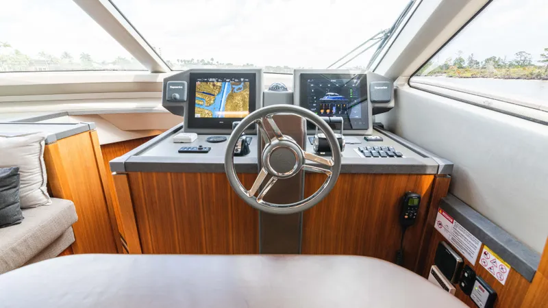 Slide: The Image of Helm of 2016 Monte Carlo Yachts MCY 65 with navigation screens and steering wheel. - 39