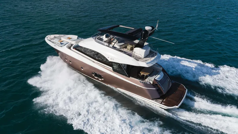 Slide: The Image of 2016 Monte Carlo Yachts MCY 65 cruising on open water, showcasing luxury and performance. - 4