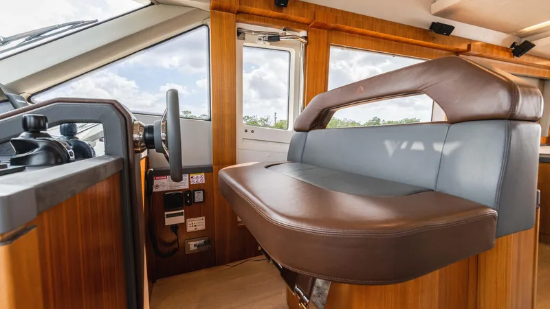 Slide: The Image of Interior helm of 2016 Monte Carlo Yachts MCY 65 with leather seating and wooden accents. - 40
