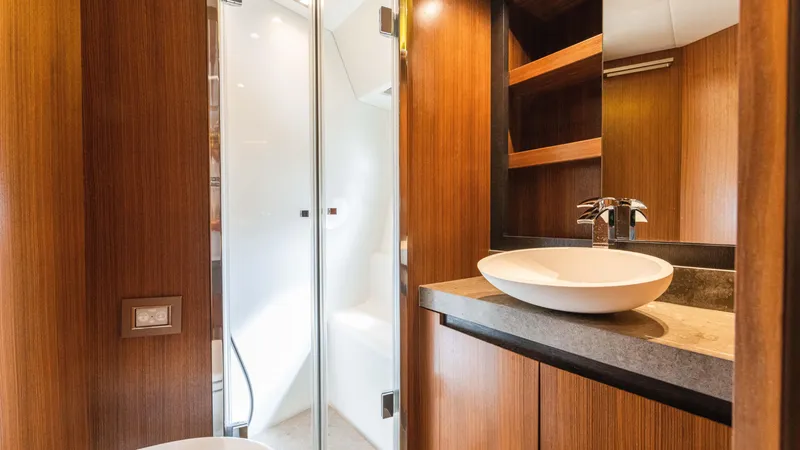 Slide: The Image of Luxurious bathroom interior of 2016 Monte Carlo Yachts MCY 65 with modern sink and wood finish. - 48