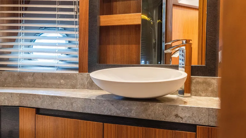 Slide: The Image of Luxurious bathroom interior of 2016 Monte Carlo Yachts MCY 65 with modern sink and porthole window. - 49
