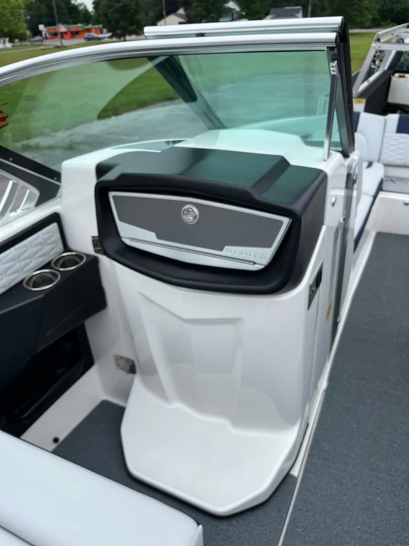 Slide: The Image of 2019 MasterCraft X26 boat interior with sleek dashboard and cup holders. - 20