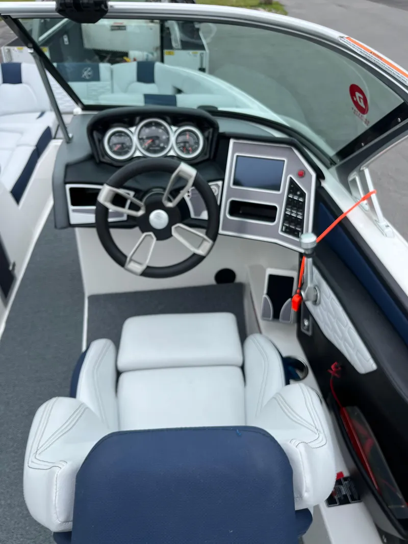 Slide: The Image of 2019 MasterCraft X26 boat interior with steering wheel and dashboard controls. - 21
