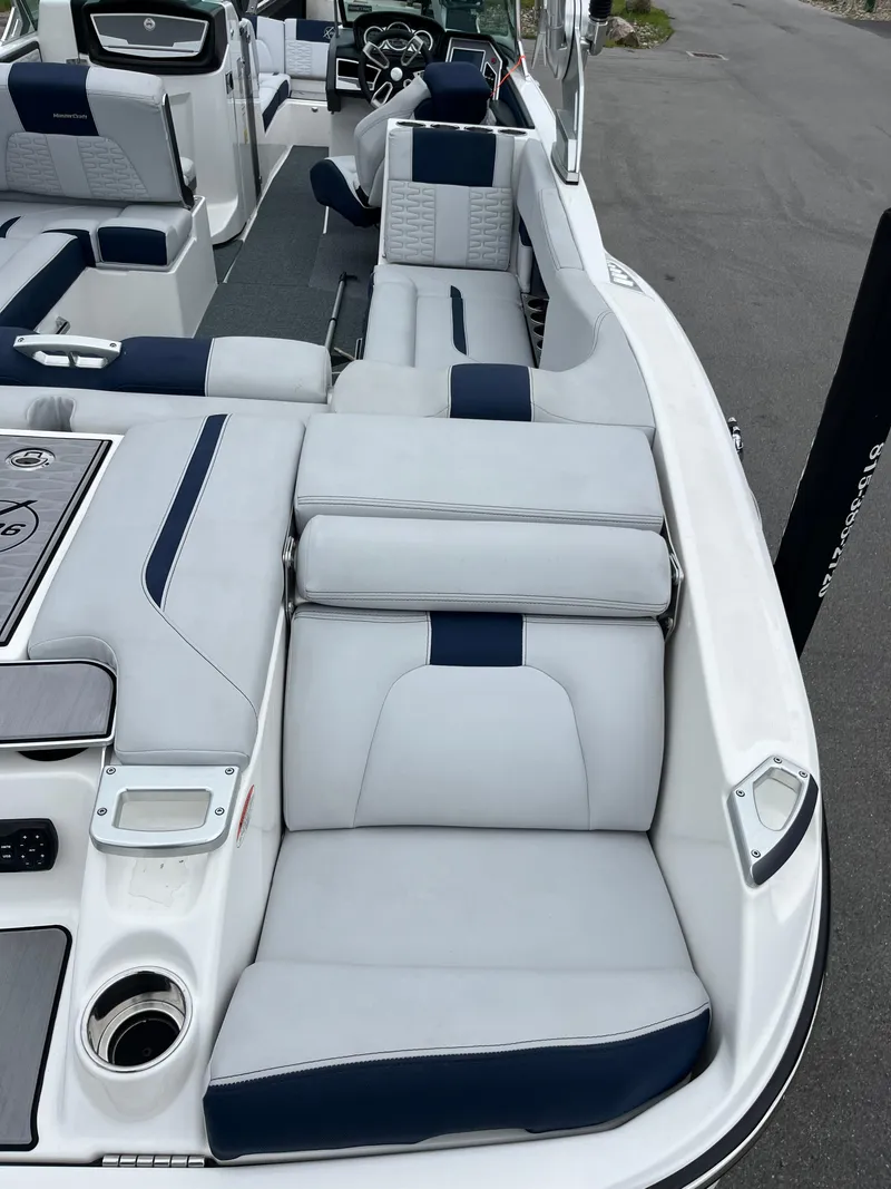Slide: The Image of 2019 MasterCraft X26 boat interior with white and navy seating. - 25