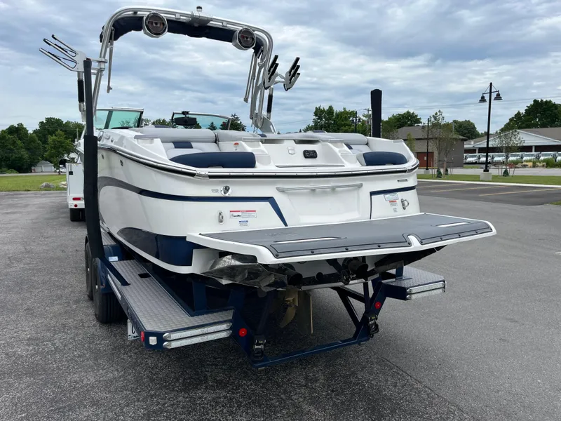 Slide: The Image of 2019 MasterCraft X26 boat on trailer, rear view, parked outdoors. - 28