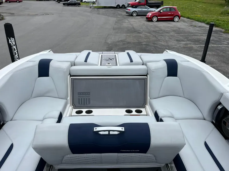 Slide: The Image of 2019 MasterCraft X26 boat interior with luxurious seating and cup holders. - 8