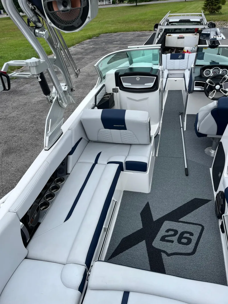Slide: The Image of 2019 MasterCraft X26 boat interior with sleek seating and modern dashboard. - 9