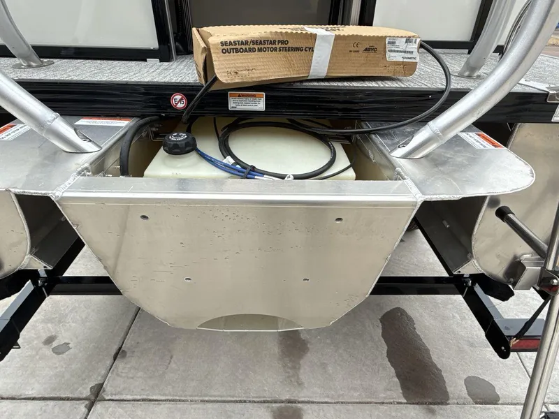 Slide: The Image of 2025 Landau ISLAND BREEZE 23 pontoon boat with exposed fuel tank and steering components. - 20