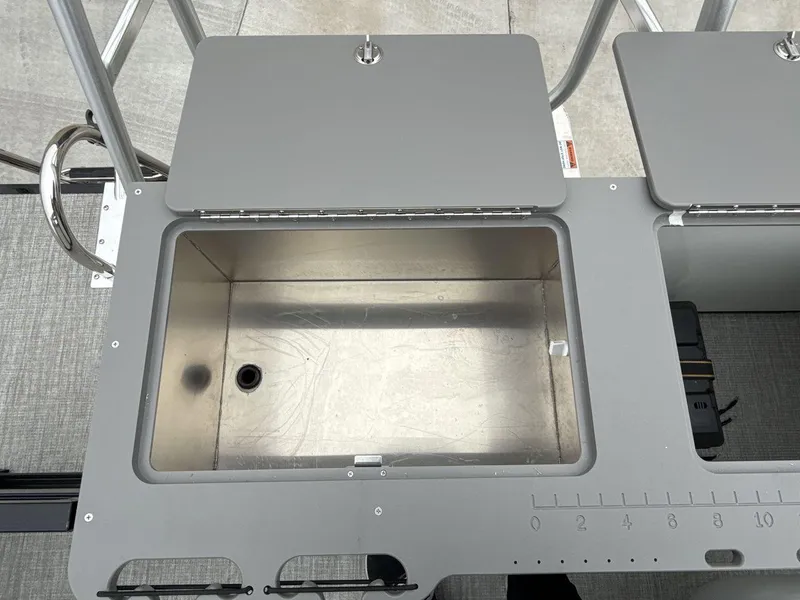 Slide: The Image of 2025 Landau ISLAND BREEZE 23 boat storage compartment with open lid and measurement markings. - 21