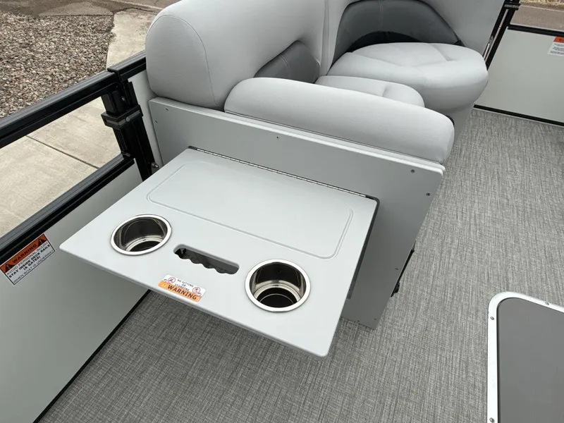 Slide: The Image of 2025 Landau ISLAND BREEZE 23 boat interior with cup holders and seating. - 23