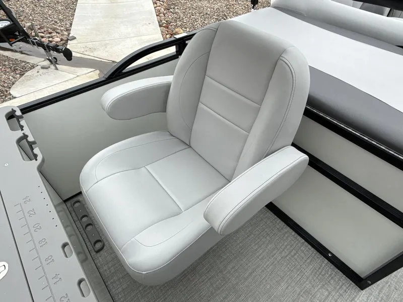 Slide: The Image of 2025 Landau ISLAND BREEZE 23 boat seat, featuring sleek gray upholstery and armrests. - 24