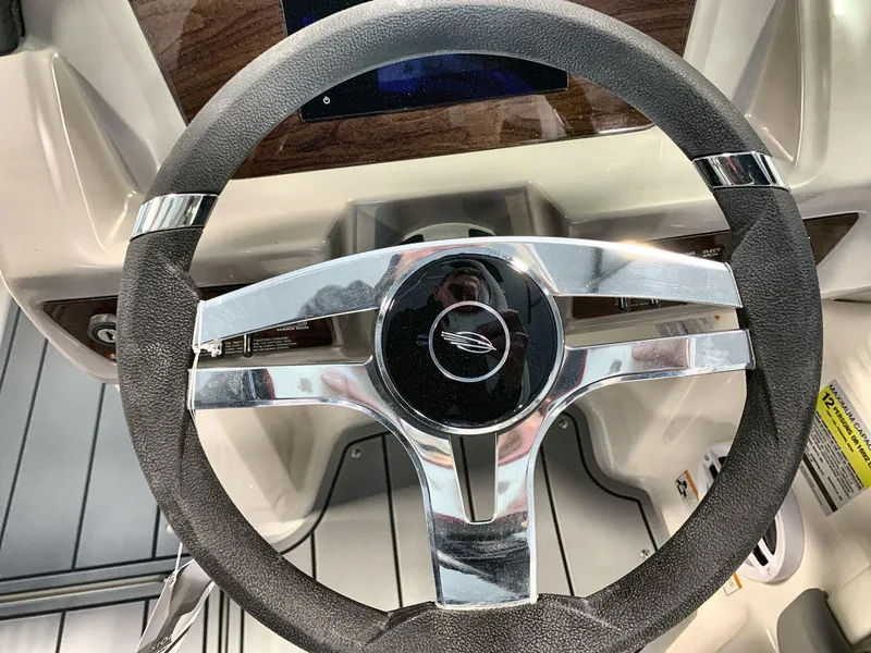 Slide: The Image of Steering wheel of 2025 Chaparral 21 SSi boat, featuring sleek chrome accents. - 14
