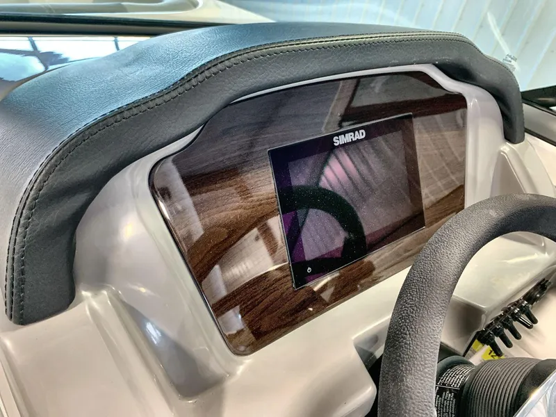 Slide: The Image of 2025 Chaparral 21 SSi dashboard with Simrad display and leather trim. - 15