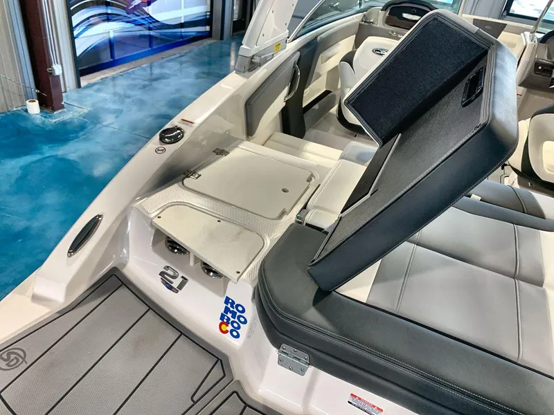 Slide: The Image of 2025 Chaparral 21 SSi boat interior with open storage compartment and sleek seating design. - 22