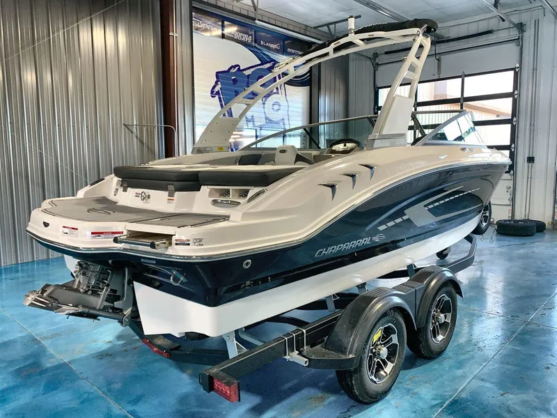 Slide: The Image of 2025 Chaparral 21 SSi boat on trailer in showroom, rear view. - 5