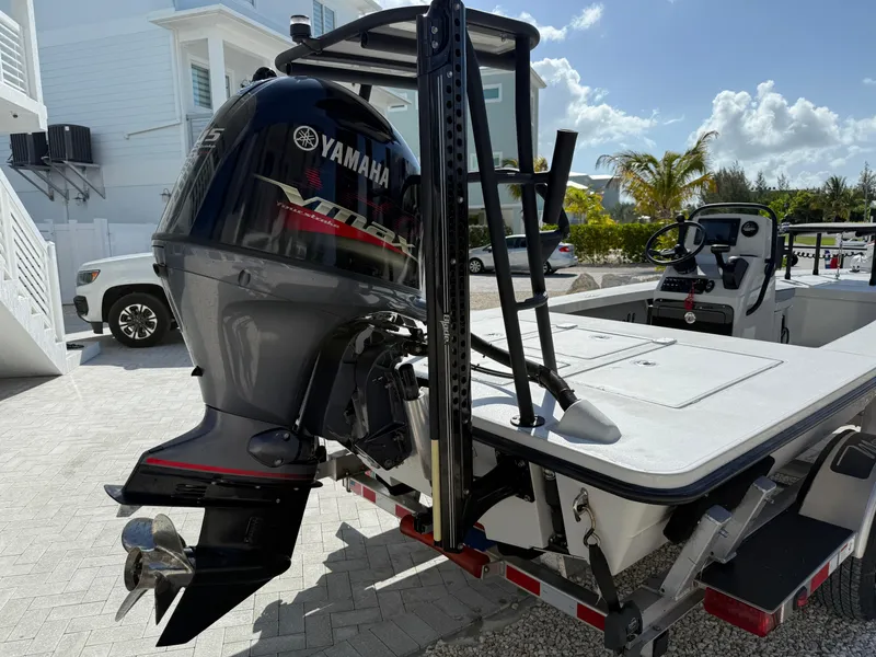 Slide: The Image of 2017 Maverick 18 HPX-V boat with Yamaha outboard motor, parked on a sunny driveway. - 10