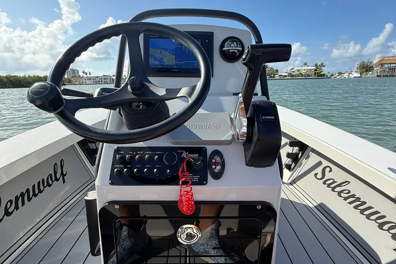 Slide: The Image of 2017 Maverick 18 HPX-V boat console with steering wheel and controls on a sunny day. - 16