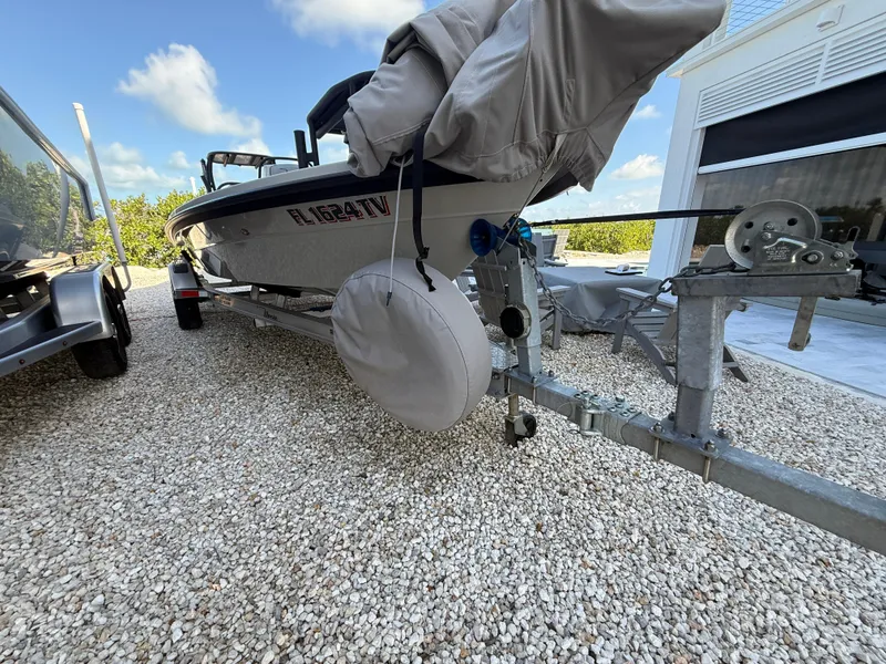 Slide: The Image of 2017 Maverick 18 HPX-V boat on trailer, covered and parked on gravel. - 21