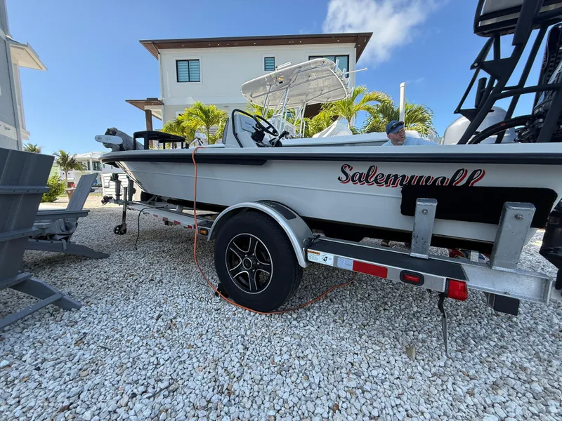 Slide: The Image of 2017 Maverick 18 HPX-V boat on trailer, parked on gravel, near modern house. - 23