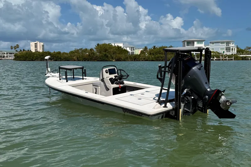 Slide: The Image of 2017 Maverick 18 HPX-V boat on calm water, with modern buildings in the background. - 3