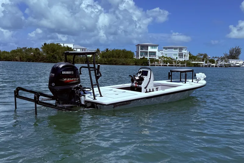 Slide: The Image of 2017 Maverick 18 HPX-V boat on water with Yamaha engine, coastal homes in background. - 4