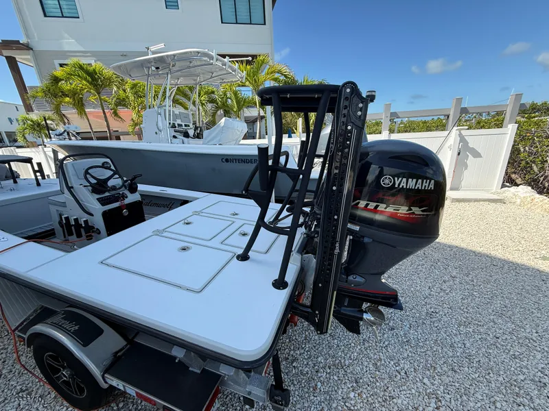 Slide: The Image of 2017 Maverick 18 HPX-V boat with Yamaha engine, parked on gravel near palm trees. - 7