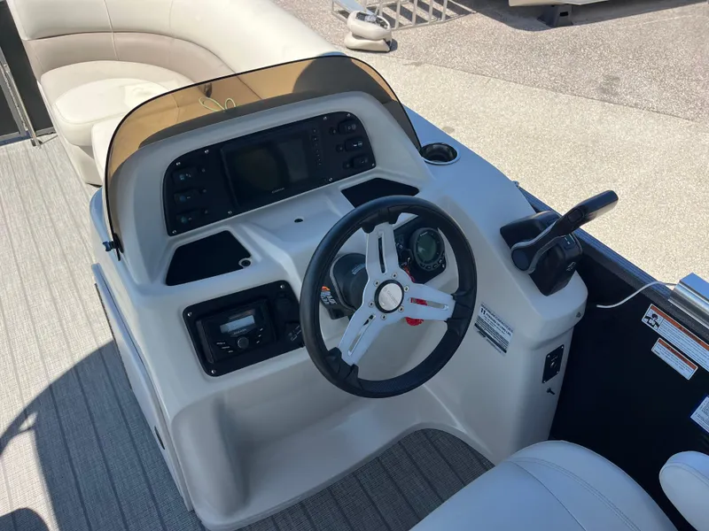 Slide: The Image of 2020 Manitou 20 Aurora LE Standard boat dashboard with steering wheel and controls. - 10