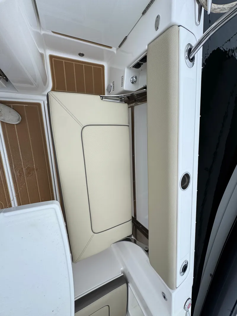 Slide: The Image of 2019 Pursuit DC 365 Dual Console boat interior with beige seating and teak flooring. - 10