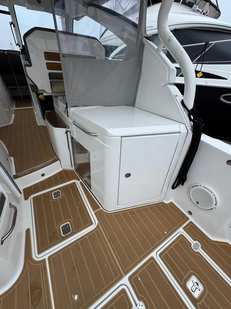 Slide: The Image of 2019 Pursuit DC 365 Dual Console interior with teak flooring and seating area. - 11