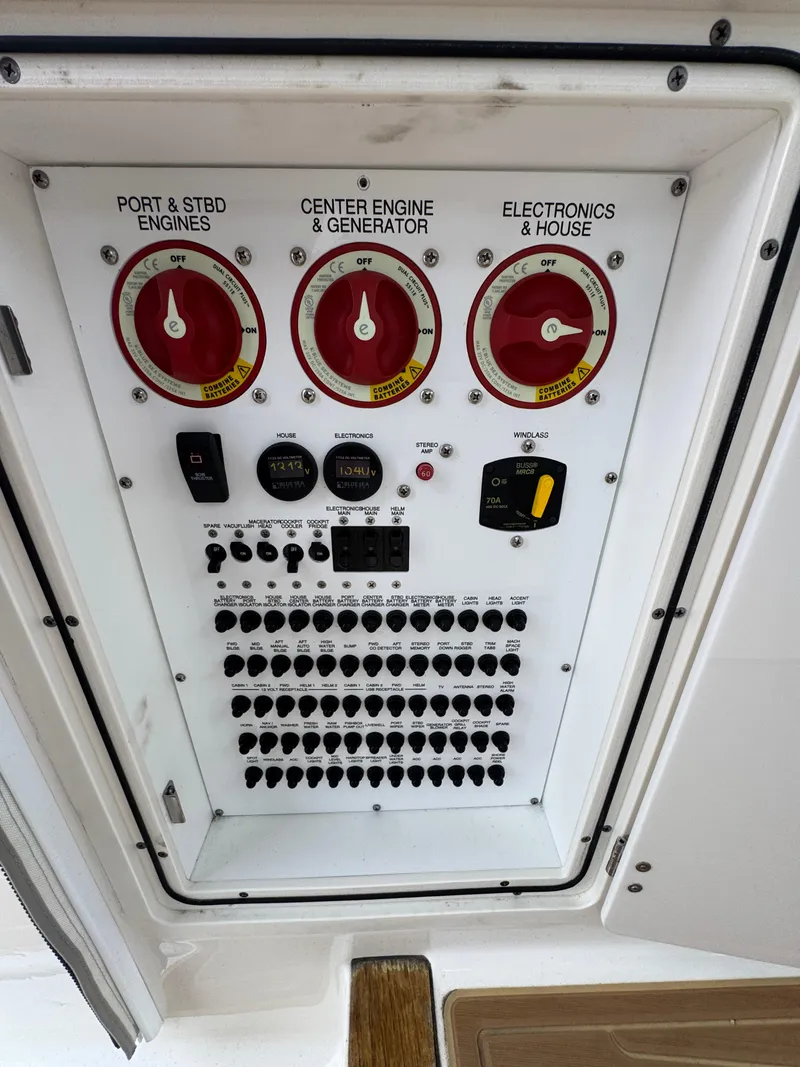 Slide: The Image of Control panel of a 2019 Pursuit DC 365 Dual Console boat with switches and dials. - 13