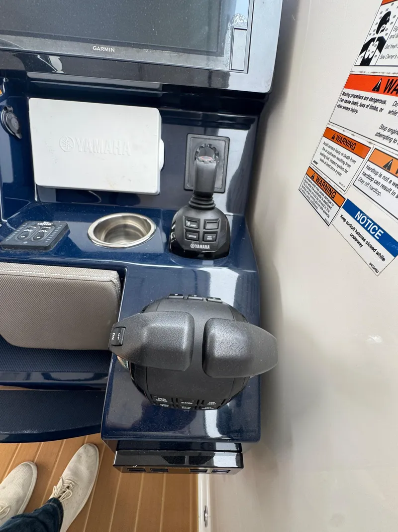 Slide: The Image of Control panel of a 2019 Pursuit DC 365 Dual Console boat with Yamaha controls. - 16