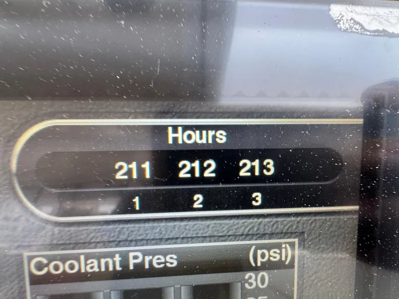 Slide: The Image of Display panel showing engine hours and coolant pressure on a 2019 Pursuit DC 365 Dual Console. - 18