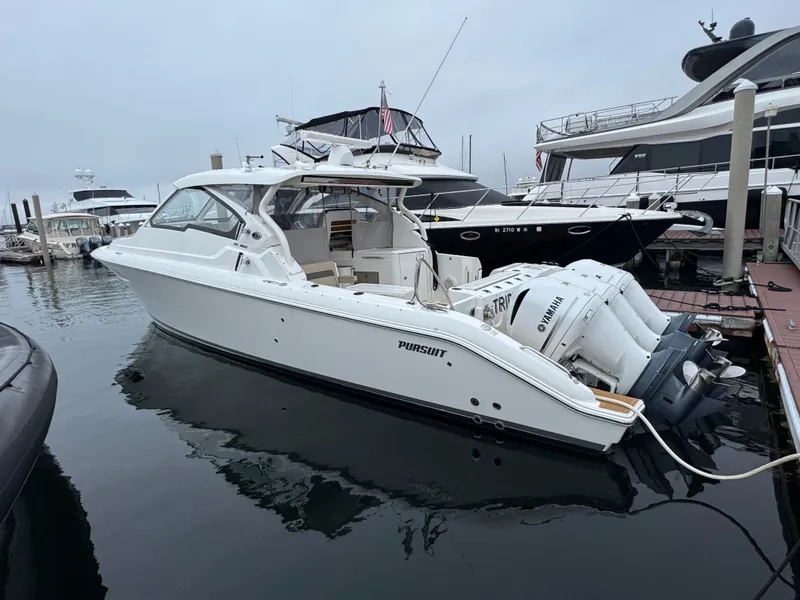Slide: The Image of 2019 Pursuit DC 365 Dual Console boat docked with Yamaha outboard engines. - 2