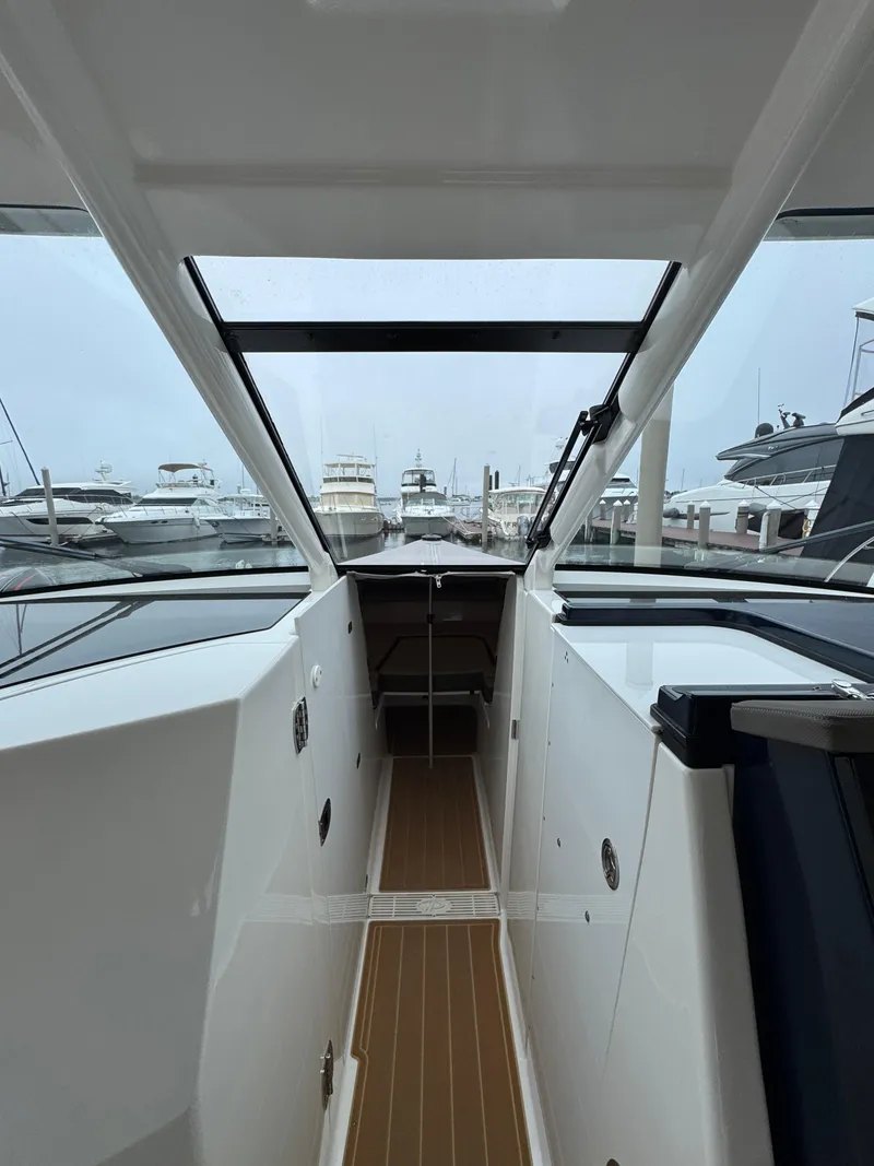 Slide: The Image of 2019 Pursuit DC 365 Dual Console boat interior with marina view. - 31
