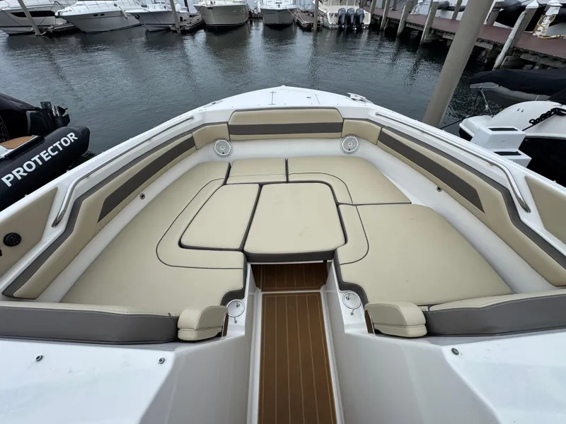 Slide: The Image of 2019 Pursuit DC 365 Dual Console boat with spacious seating at marina. - 32