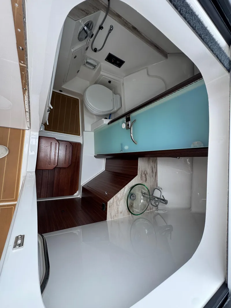 Slide: The Image of 2019 Pursuit DC 365 Dual Console interior with modern bathroom and wooden accents. - 34