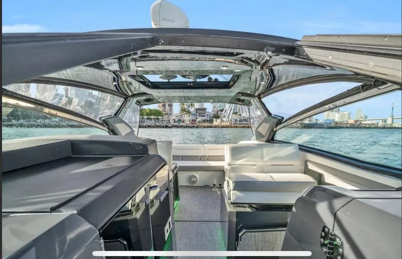 Slide: The Image of Interior view of a 2018 Cobalt A36 boat with luxurious seating and panoramic windows. - 3