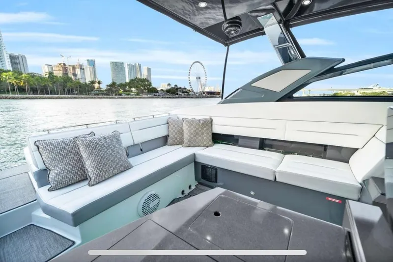 Slide: The Image of Luxurious 2018 Cobalt A36 boat interior with city skyline and Ferris wheel view. - 6