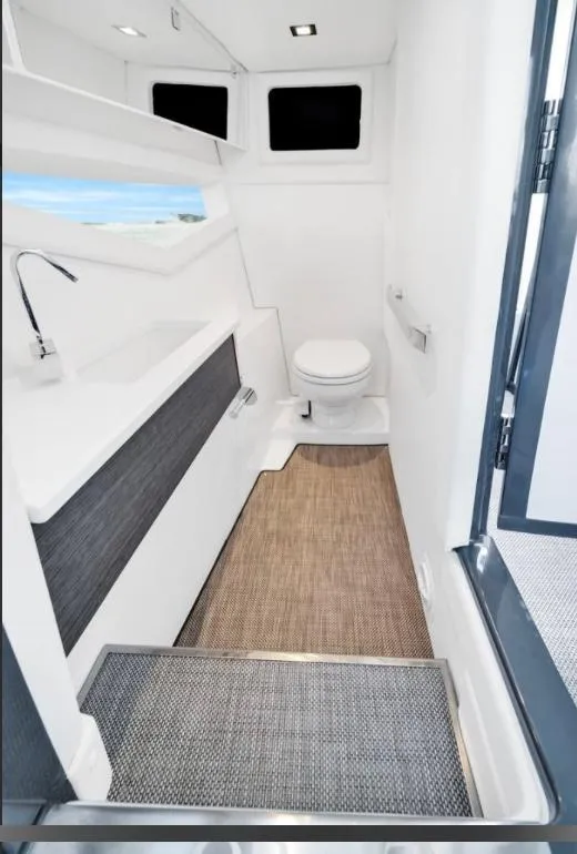 Slide: The Image of Modern bathroom interior on a 2018 Cobalt A36 boat, featuring sleek design and compact layout. - 8