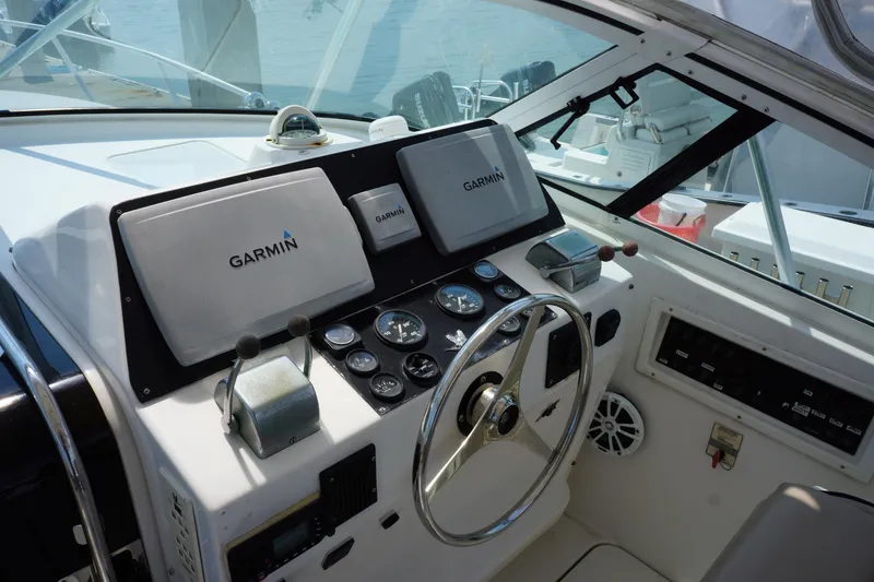 Slide: The Image of Cockpit of 1997 Bertram 36 Moppie with Garmin navigation system and steering wheel. - 12