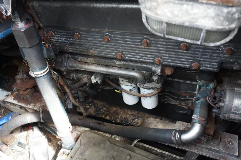 Slide: The Image of Engine compartment of a 1997 Bertram 36 Moppie boat, showing mechanical components and wiring. - 20