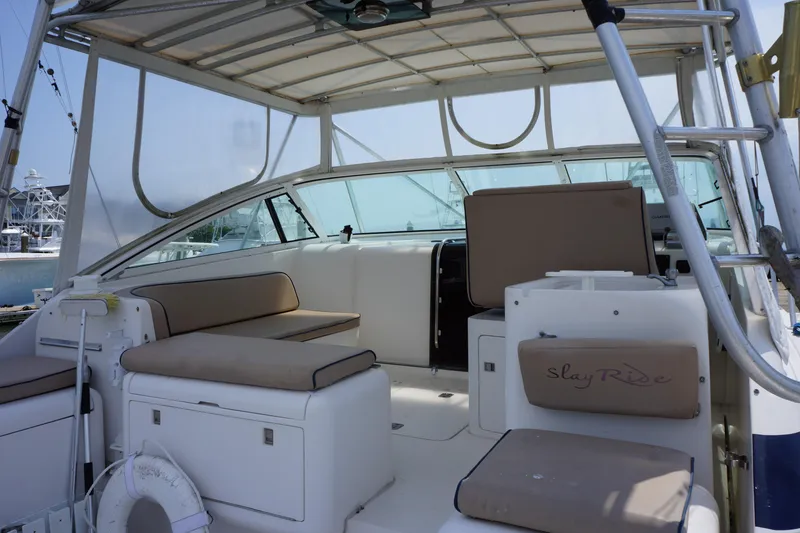 Slide: The Image of 1997 Bertram 36 Moppie boat interior with cushioned seating and open deck. - 9